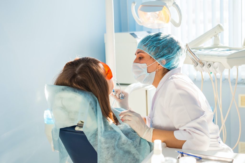 young woman getting dental treatment dental clinic مجتبی صیدی دکتر دندان پزشک